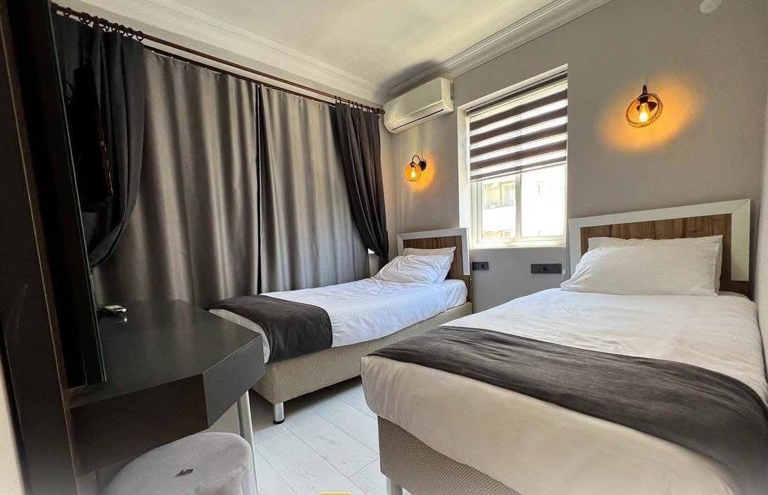 Spacious twin bedroom with curtains